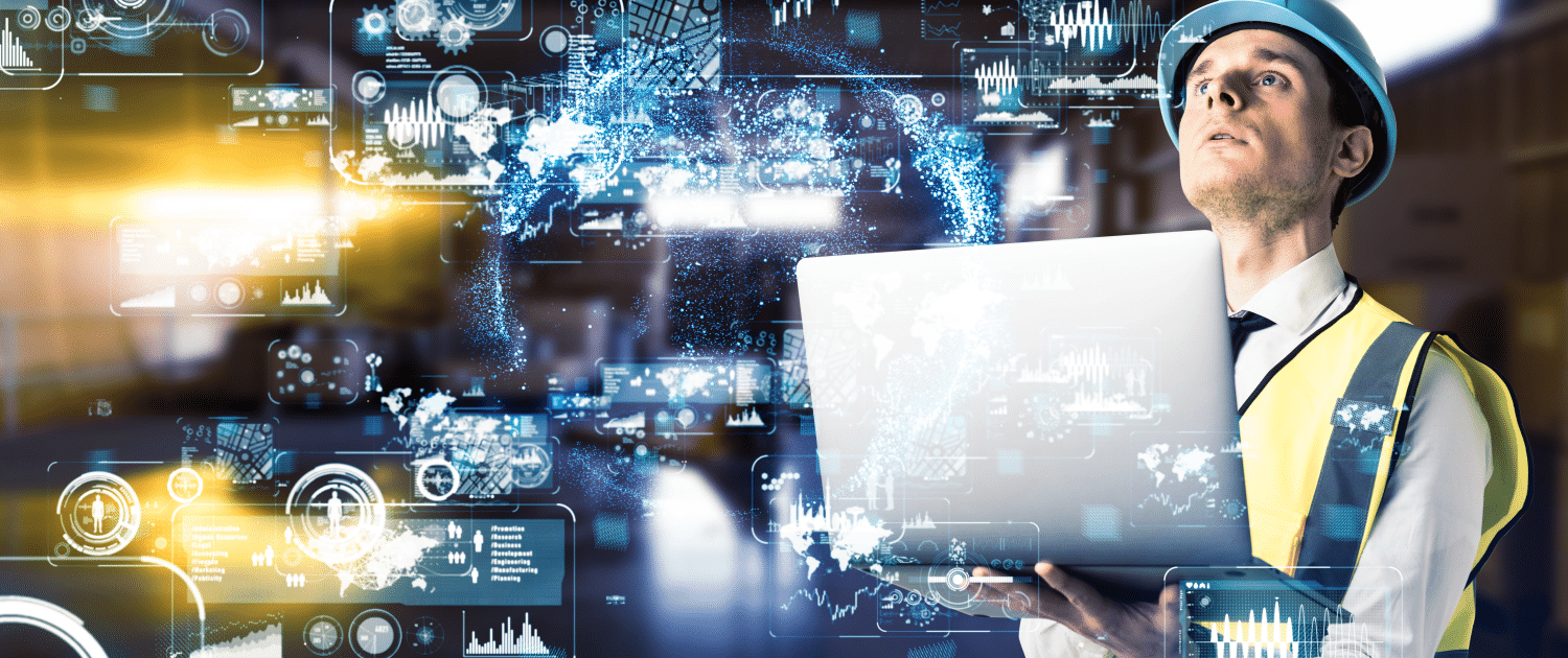 A man wearing a construction vest and hard hat holding a silver laptop and looking up. To the left of him are several transparent graphs and metrics